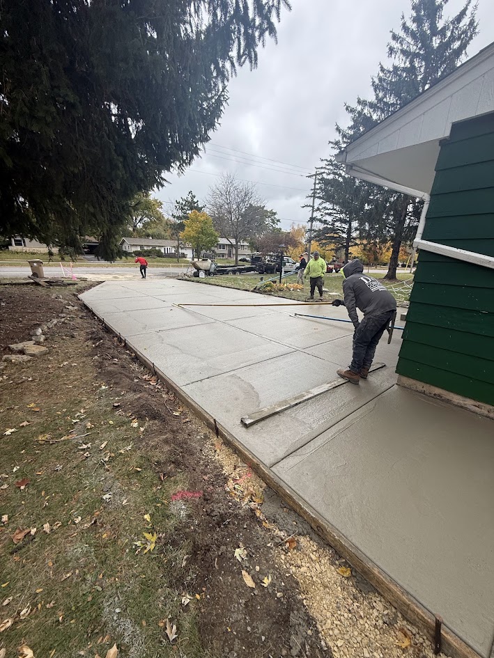 D&M Concrete crew finishing a residential sidewalk pour